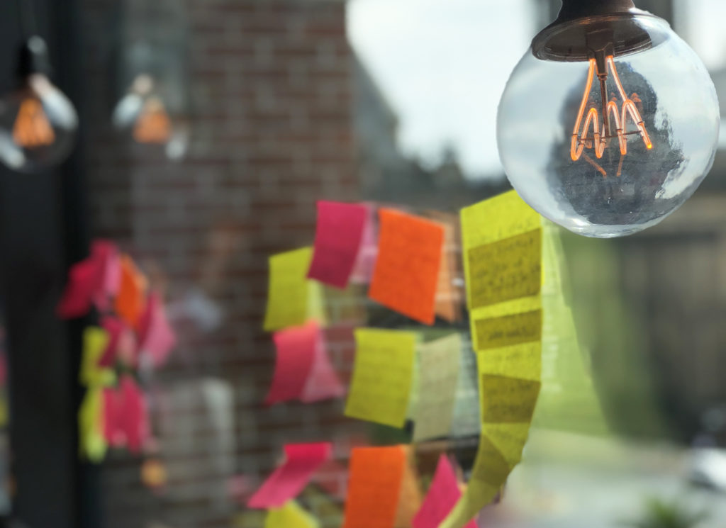 Post-its on a window with lightbulb above