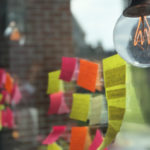 Post-its on a window with lightbulb above